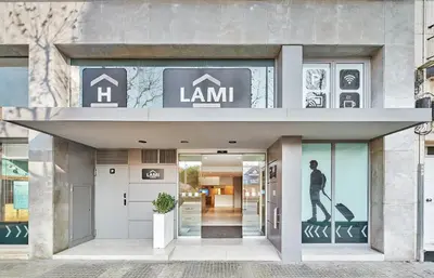 a building with a man walking into the front door at Hostal Lami in Esplugues de Llobregat