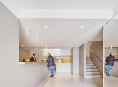 a man walking down the hallway of a building at Hostal Lami in Esplugues de Llobregat