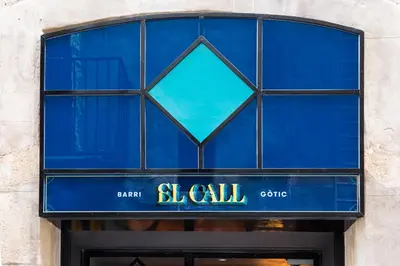 a blue glass window over a store door at Hotel El Call in Barcelona