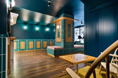 a play room with blue walls and a table at Hotel El Call in Barcelona