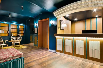 a room with blue walls and a table and chairs at Hotel El Call in Barcelona