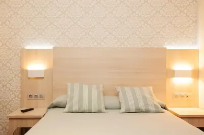 a bedroom with a bed with two pillows at Hostal Fernando in Barcelona