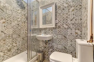 a bathroom with a toilet and a sink and a shower at Factory Suites Barcelona in Barcelona
