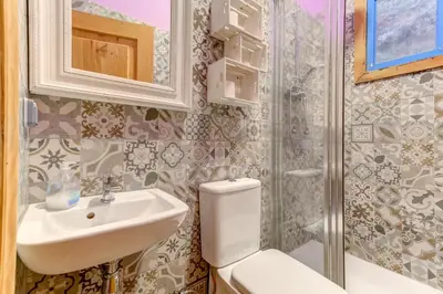 a bathroom with a toilet and a sink and a shower at Factory Suites Barcelona in Barcelona