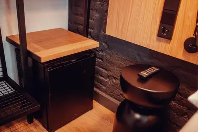 a bathroom with a stool with a remote control on it at Hotel Transit in Barcelona