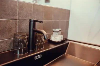 a kitchen counter with a sink and a faucet at Hotel Transit in Barcelona