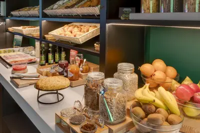 a shelf filled with lots of different types of food at B&B HOTEL Barcelona Granollers in Les Franqueses del Vallès