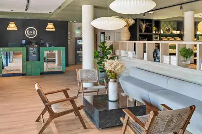 a lobby with chairs and a table in a store at B&B HOTEL Barcelona Granollers in Les Franqueses del Vallès