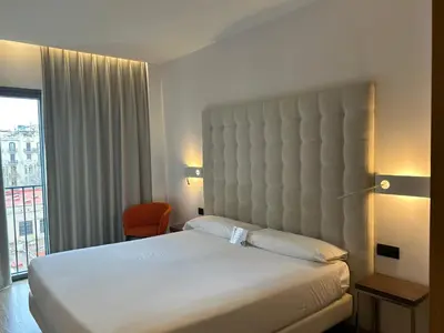 a hotel room with a bed and a large window at Chi in Barcelona