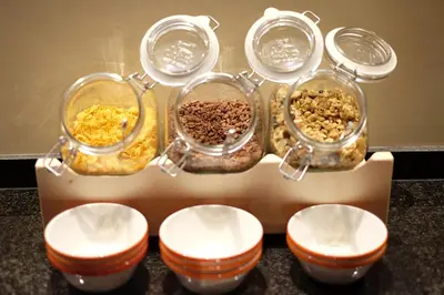 four glass containers filled with different types of food at Chi in Barcelona