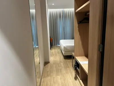 a hotel room with a bed and a mirror at Chi in Barcelona