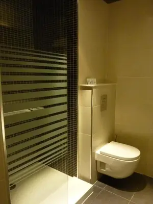 a bathroom with a toilet and a glass shower at Barcelona House in Barcelona