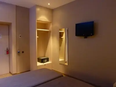 a bedroom with a bed and a television on the wall at Barcelona House in Barcelona