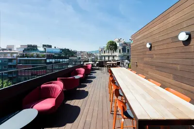 a row of benches on a balcony of a building at The Corner Hotel in Barcelona