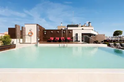 a large swimming pool on top of a building at The Corner Hotel in Barcelona
