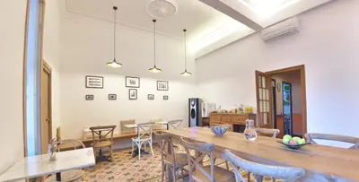 a dining room with a long table and chairs at Hostal Girona in Barcelona