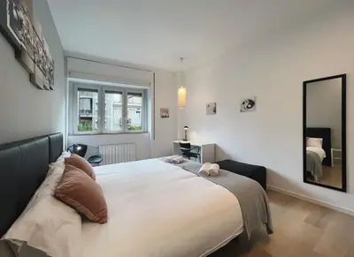 a bedroom with a large bed and a mirror at Stay U-nique Apartments Sants in Barcelona