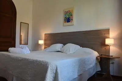 a bedroom with a large bed with two white pillows at Ally's Bed&Breakfast, in Barcelona