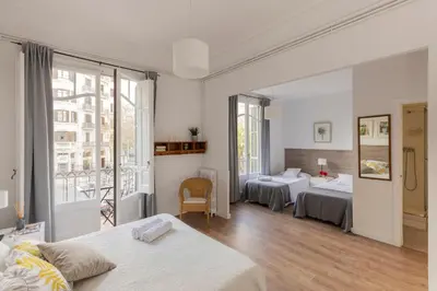a hotel room with two beds and a balcony at Ally's Bed&Breakfast, in Barcelona