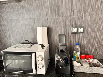 a microwave sitting on a counter next to a blender at Apartaments IRI in Pineda de Mar