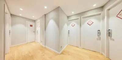 an empty hallway with white walls and wood floors at Barcelona Century Hotel in Barcelona