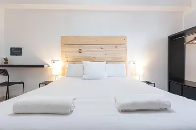 a bedroom with a large white bed with two pillows at Easy Sants by Bossh! Hotels in Barcelona