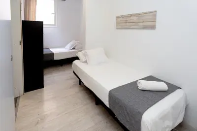 a small room with a bed and a mirror at Easy Sants by Bossh! Hotels in Barcelona