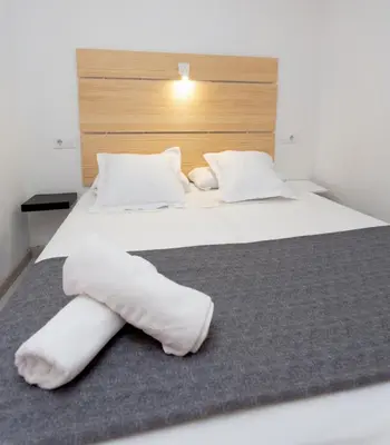 a bedroom with a bed with white towels on it at Easy Sants by Bossh! Hotels in Barcelona