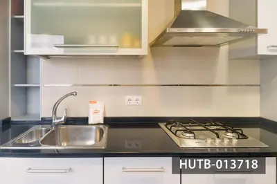 a kitchen with a sink and a stove at Blanco Vinyet in Sitges