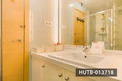 a bathroom with a white sink and a mirror at Blanco Vinyet in Sitges