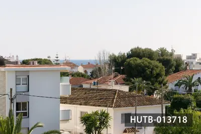 a white building with a sign on the side of it at Blanco Vinyet in Sitges