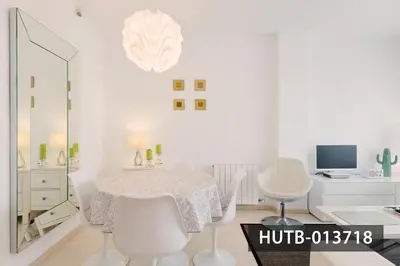 a white dining room with a table and chairs at Blanco Vinyet in Sitges