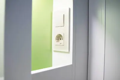 a mirror on a door with a light switch at Sant Jordi Hostels Sagrada Familia in Barcelona