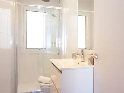 a white bathroom with a sink and a shower at Stay U-nique Apartments Sant Pau in Barcelona