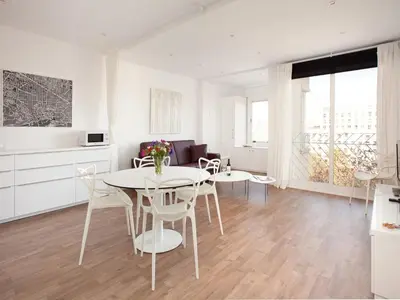 a kitchen and living room with a table and chairs at Stay U-nique Apartments Sant Pau in Barcelona