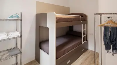 a room with bunk beds and a closet at Hotel Sagrada Familia Apartments in Barcelona