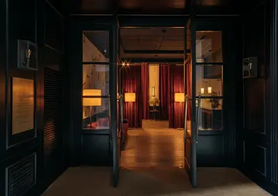 a room with a table and chairs and windows at Wittmore Hotel GL- Adults Only, Small Luxury Hotels in Barcelona