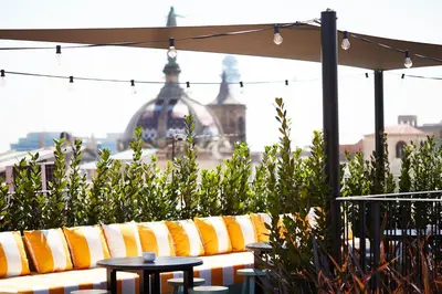 a bedroom with a bed and a table with a phone at Wittmore Hotel GL- Adults Only, Small Luxury Hotels in Barcelona
