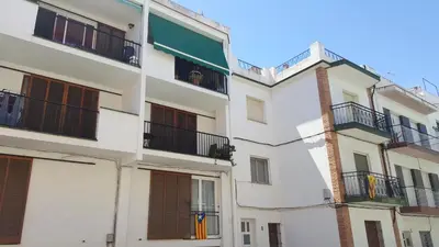 an apartment building with balconies on the side of it at Apartamento Hector en Sitges in Sitges