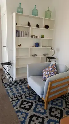 a living room with a couch and a rug at The Sky Attic Apartment in Sitges