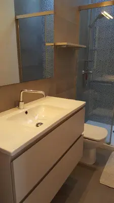 a bathroom with a sink and a toilet and a shower at The Sky Attic Apartment in Sitges