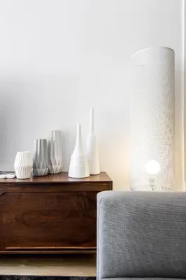 a room with a table with vases and a lamp at Super central 3BR apartment, spacious and bright in Barcelona