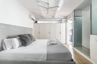 a bedroom with a bed with a ceiling fan at Super central 3BR apartment, spacious and bright in Barcelona
