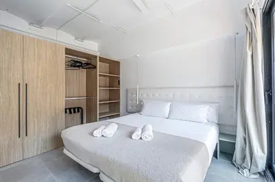 a bedroom with a bed with two white slippers on it at Super central 3BR apartment, spacious and bright in Barcelona