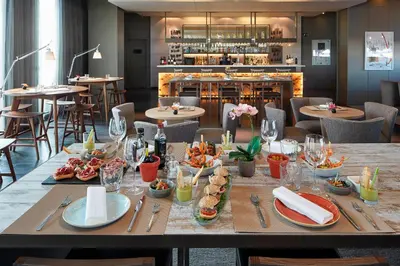 a table with food on it in a restaurant at AC Hotel Sants by Marriott in Barcelona