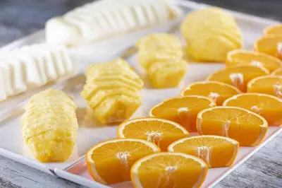 a plate with peeled orange slices on a table at AC Hotel Sants by Marriott in Barcelona