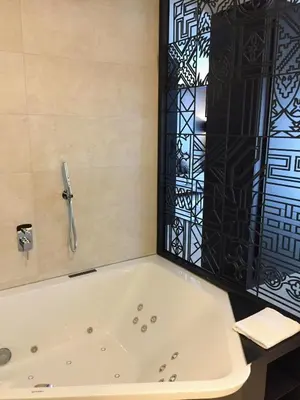 a bath tub with a shower in a bathroom at Vila Arenys Hotel in Arenys de Mar