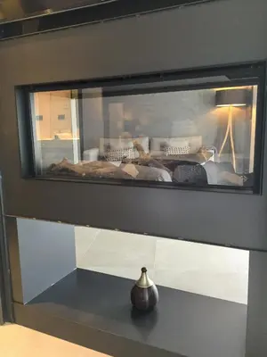 a room with a fireplace with a bed in it at Vila Arenys Hotel in Arenys de Mar