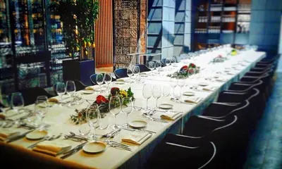 a long table with plates and wine glasses at Vila Arenys Hotel in Arenys de Mar