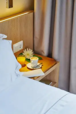 a small table with a cup of coffee and a flower at Hotel Arrey Alella in Alella